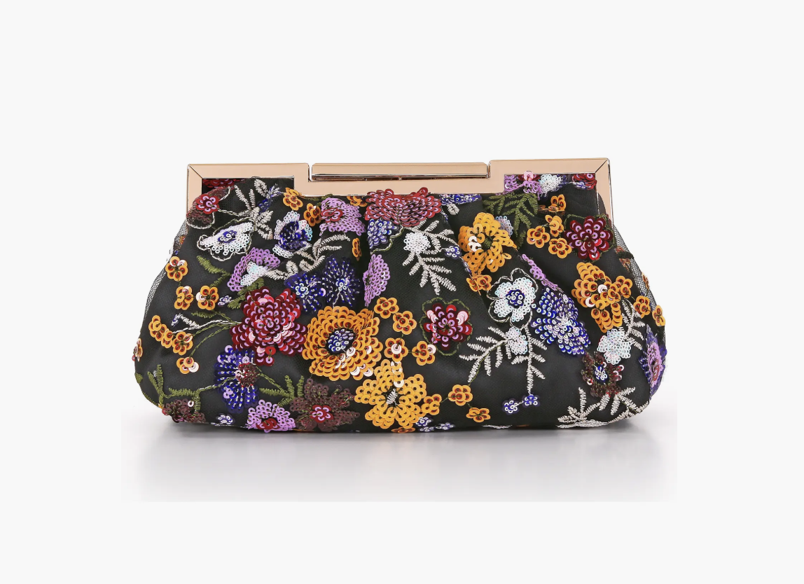 Brocade evening handbag styled with a black dress, tights and a tailored coat.