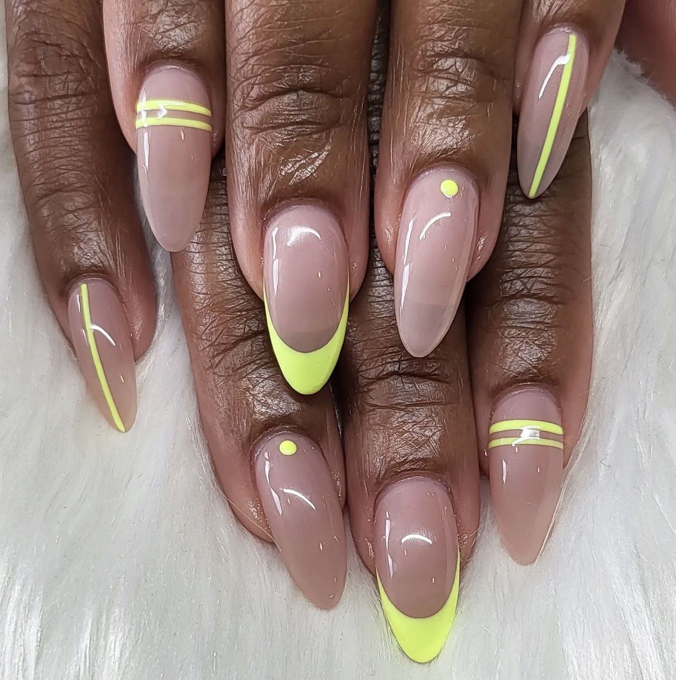 Sheer nails with asymmetrical lime-green side French tips