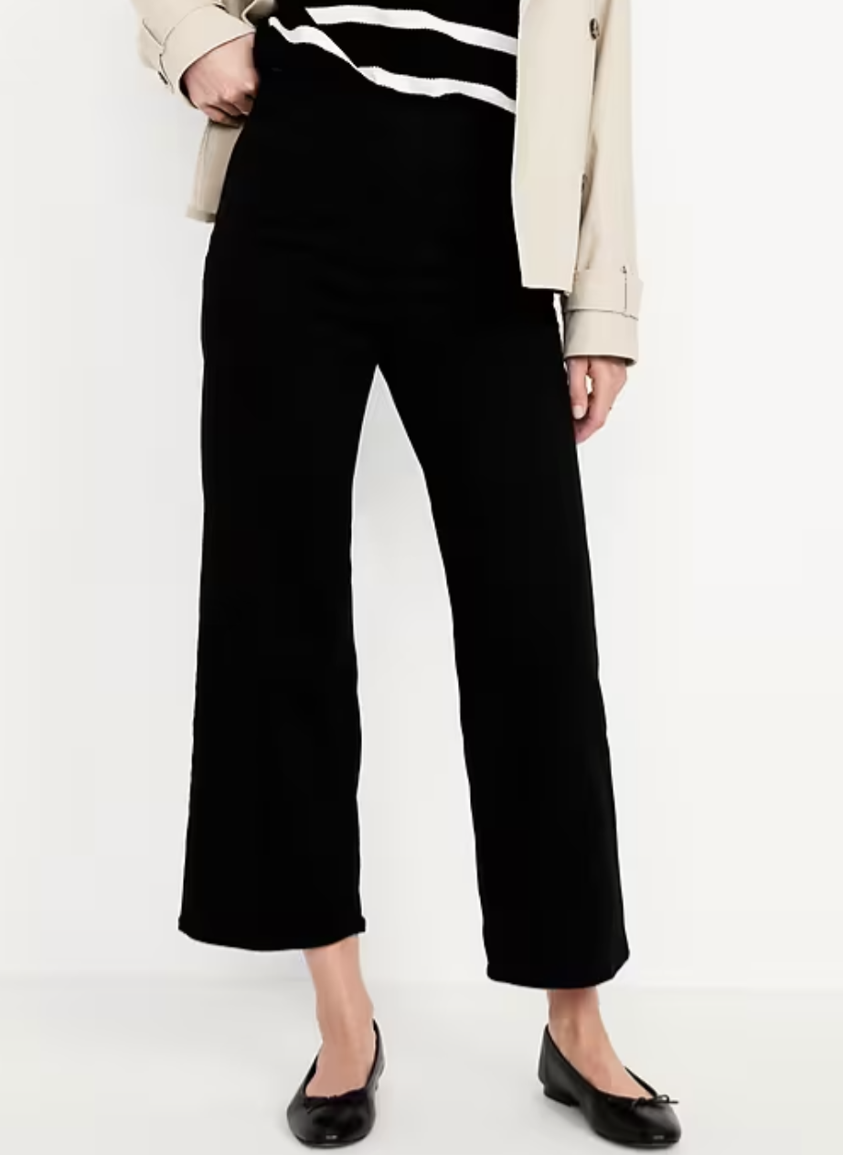 A woman wearing black [Gap High-Waisted Weekender Pull-On Crop Wide-Leg Jeans](https://bit.ly/4kPDxE2) paired with black pointed-toe ballet flats. These comfortable stretch jeans feature a high-rise waist and a trendy cropped wide-leg silhouette.