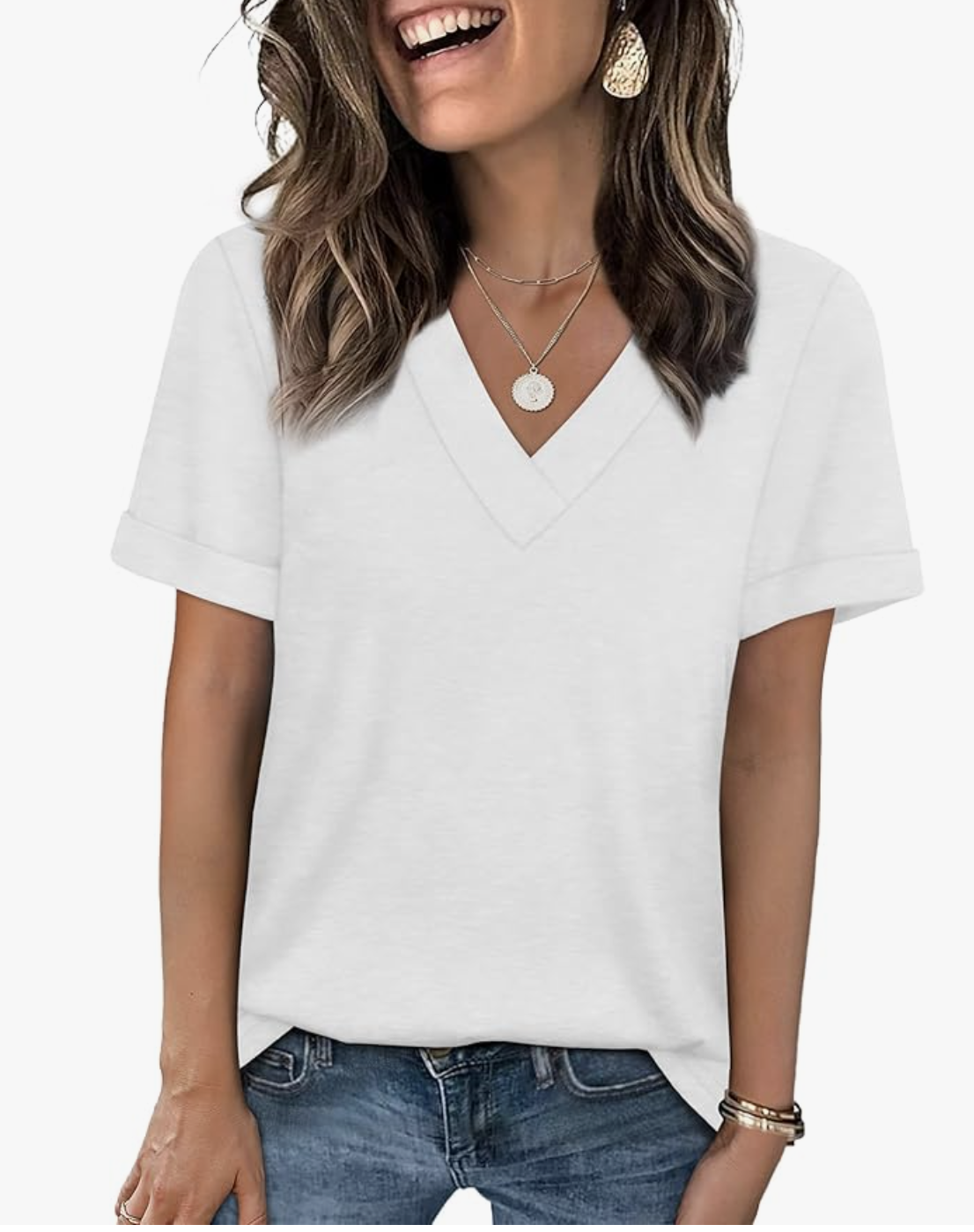 A woman wearing a classic white short-sleeve V-neck t-shirt tucked into blue jeans.