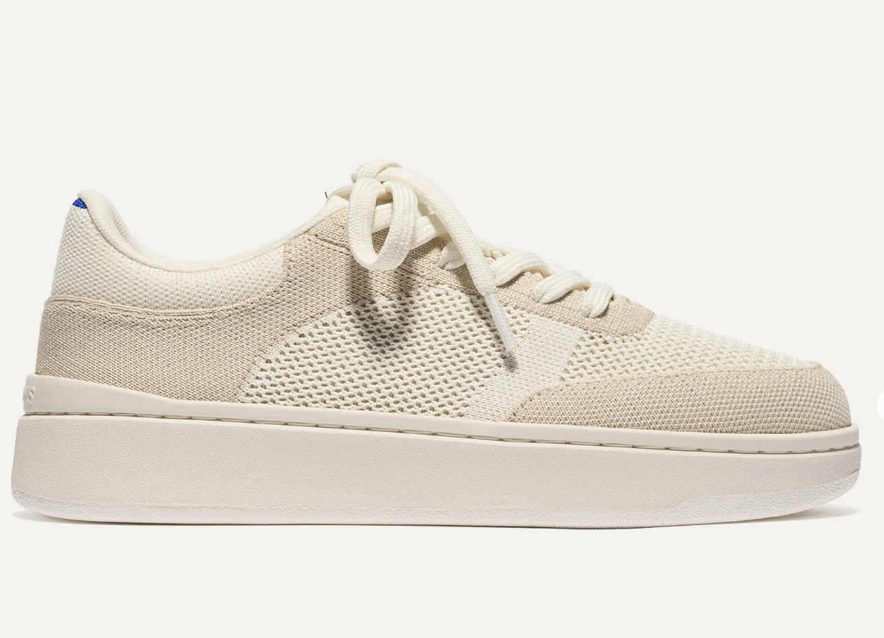 A pair of off-white Rothy’s Court-Style knit sneakers, featured as the best washable and sustainable work sneakers for a professional office.