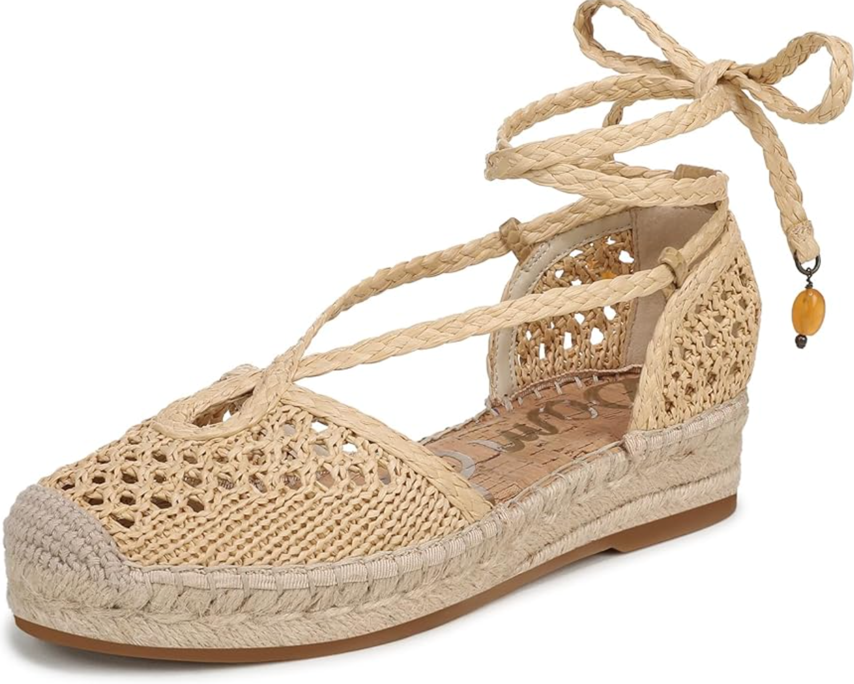 A pair of cream-colored crochet espadrille sandals from Free People, featuring a woven almond toe and long rope wrap-around ankle ties on a transparent background.