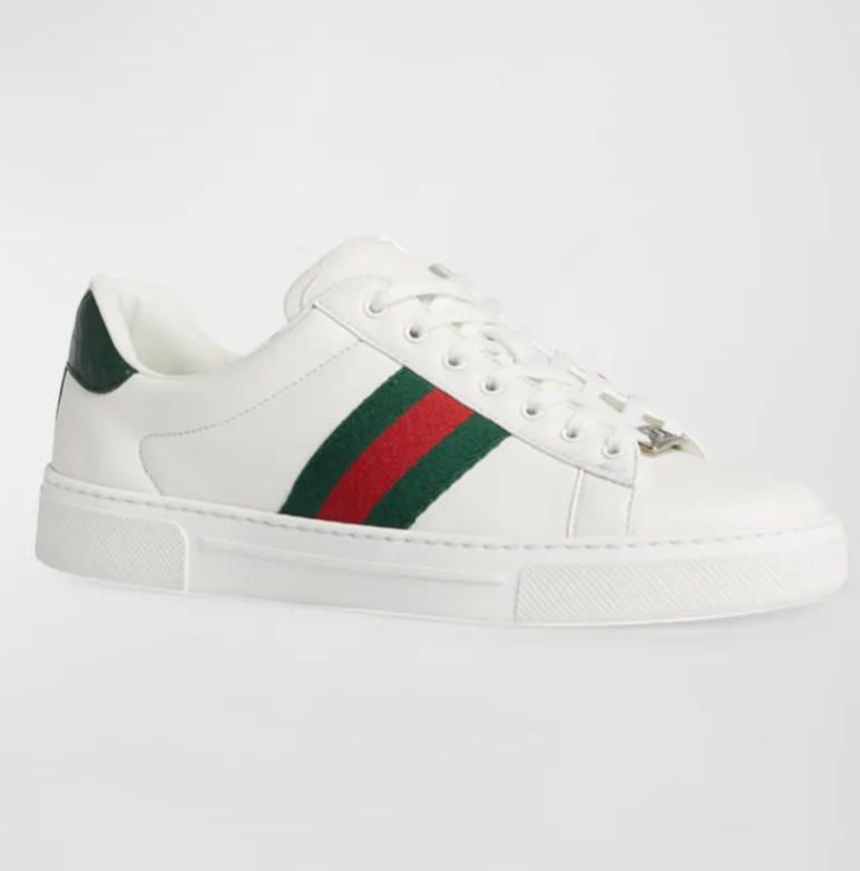 Side view of the Gucci Ace Leather Web Low-Top Sneakers in white leather, featuring the iconic green and red web stripe and a metallic green heel tab.