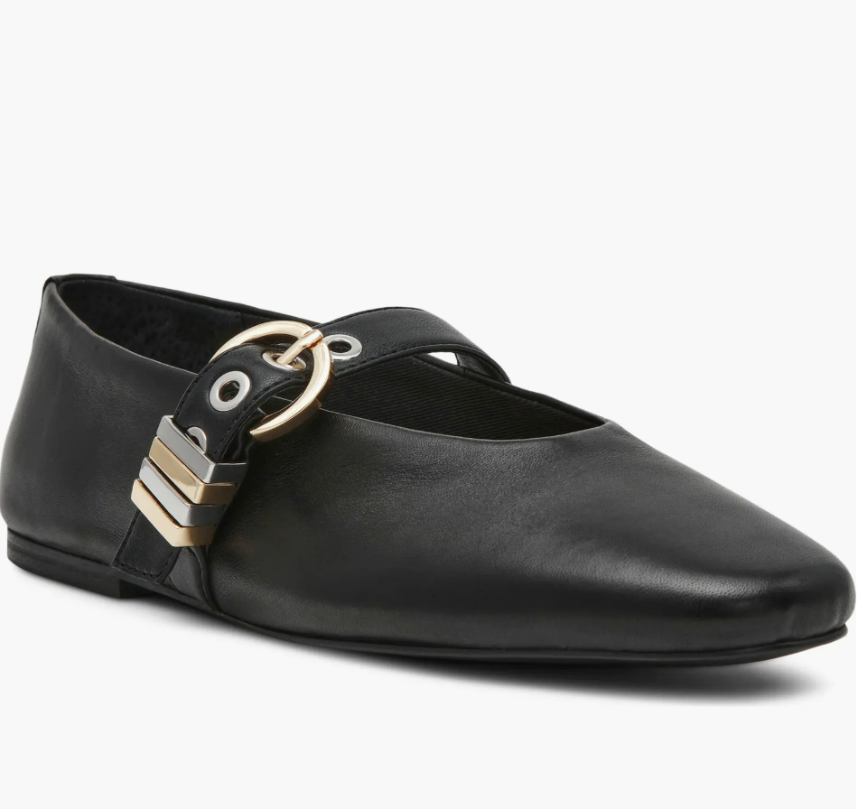 A black leather Mary Jane flat for women by Steve Madden featuring a square toe and a chunky silver grommet-studded strap with a large buckle.