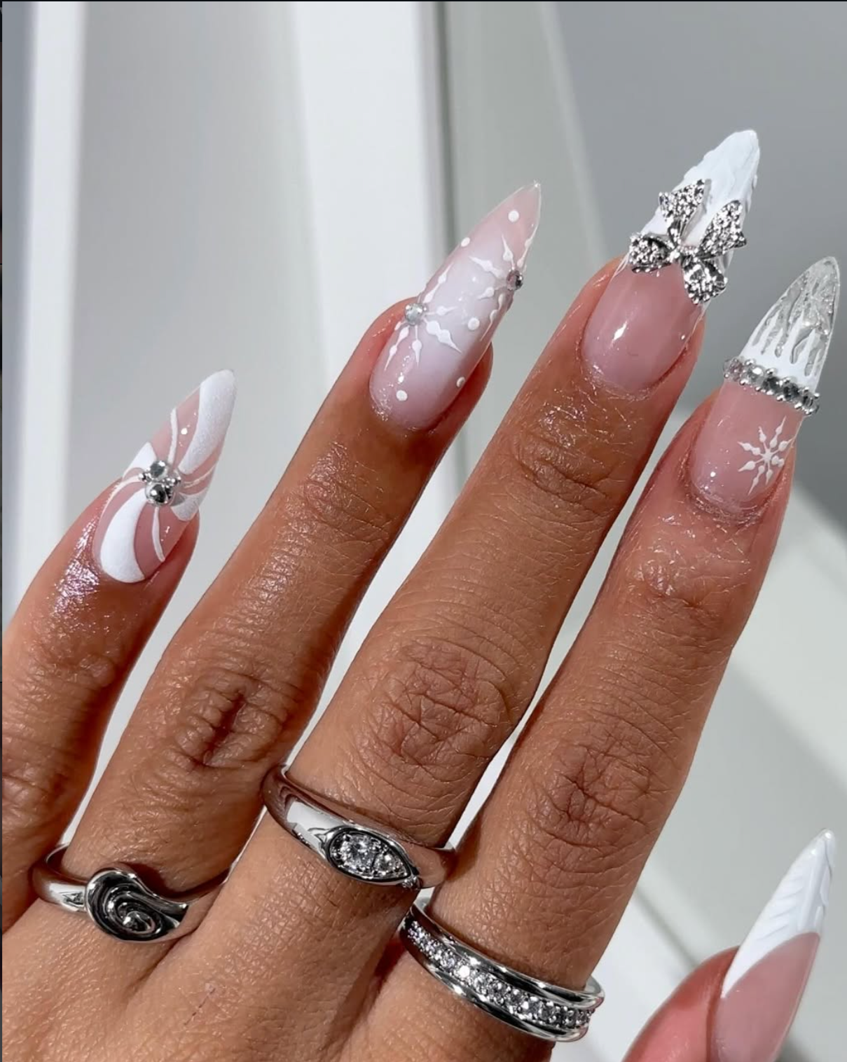 Icy silver chrome Christmas nails with a reflective winter finish