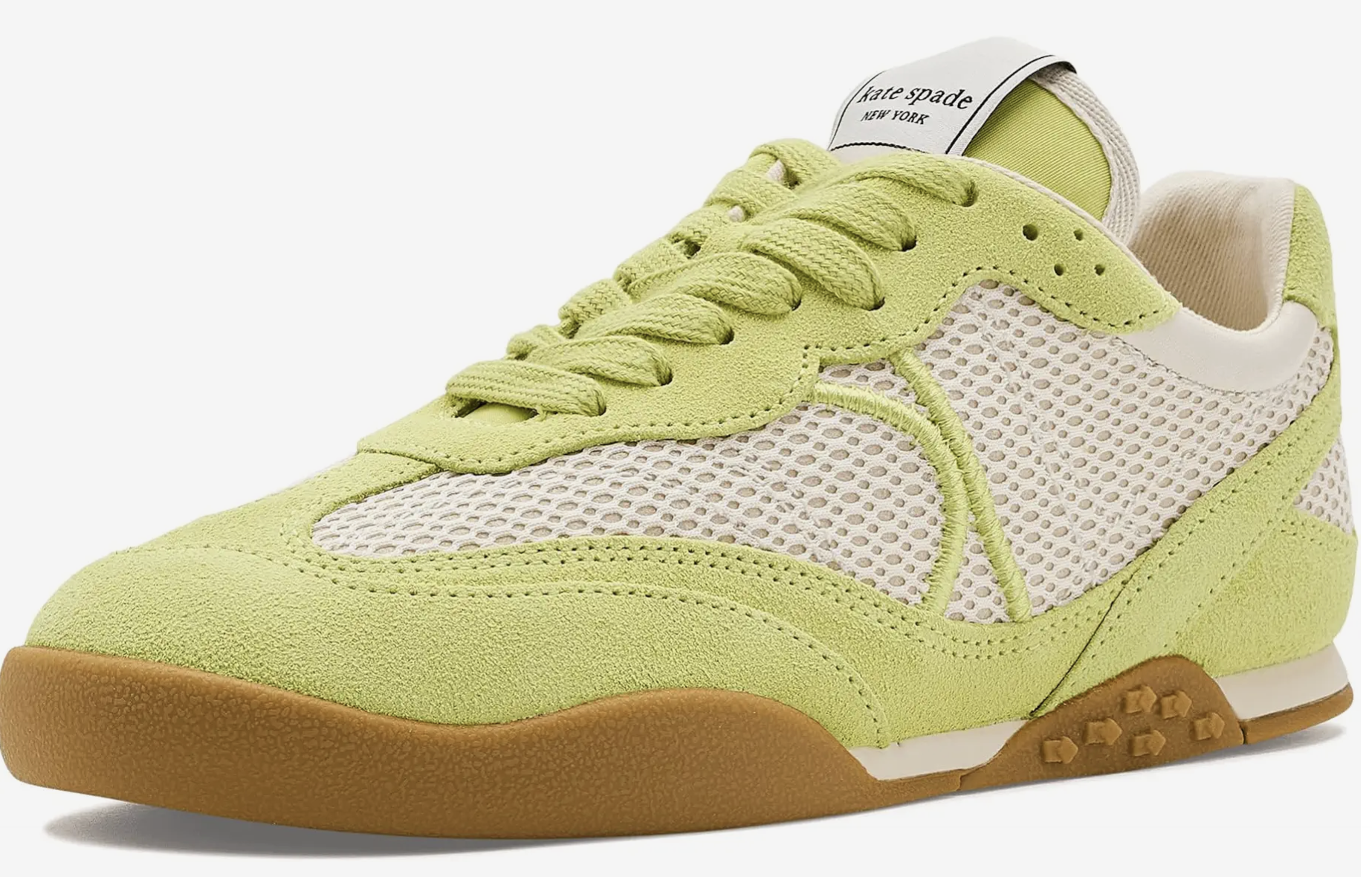 Pale pistachio green suede and mesh low-top sneaker featuring a brown gum sole and white laces.
