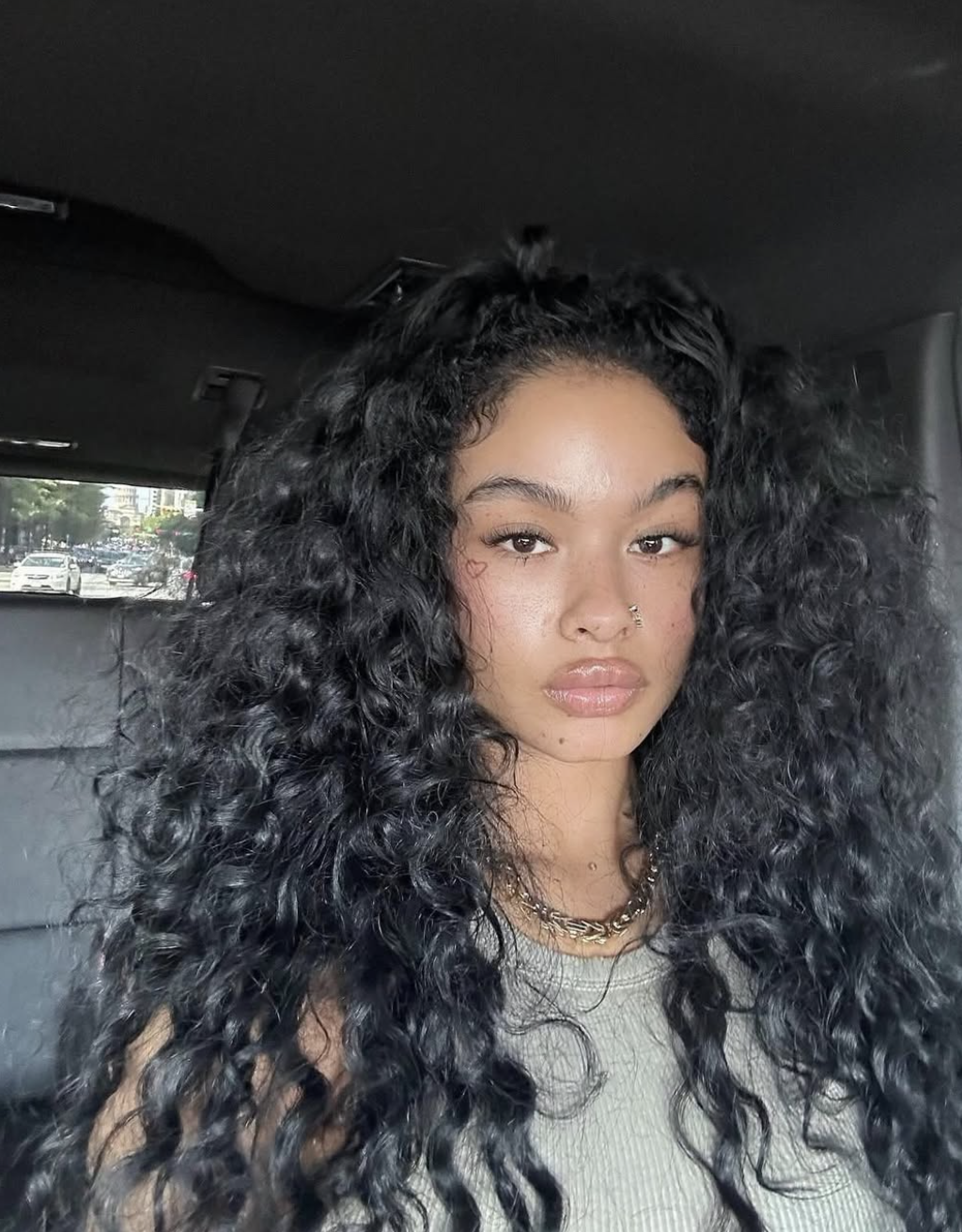 "India Love sporting long, voluminous loose curls that provide a soft contrast to a defined, square face shape."
