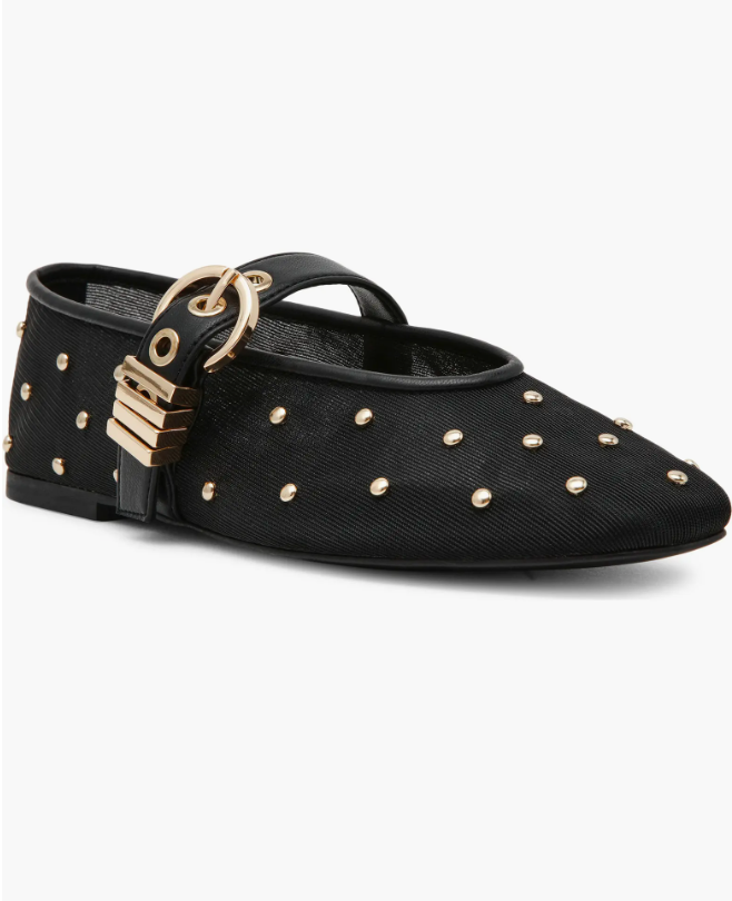 Black studded Steve Madden Mary Jane flats styled with brown trousers to create a modern and edgy contrast.