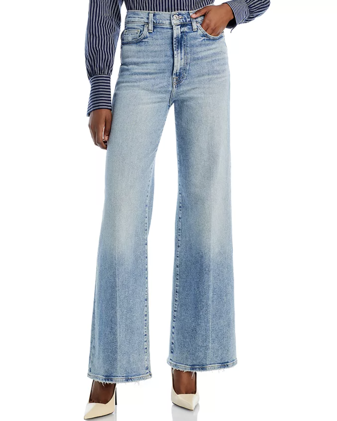 Model wearing 7 For All Mankind Jo Ultra High-Rise Wide Leg Jeans in a light wash, featuring a flared silhouette that adds curves to a rectangle or athletic body shape.