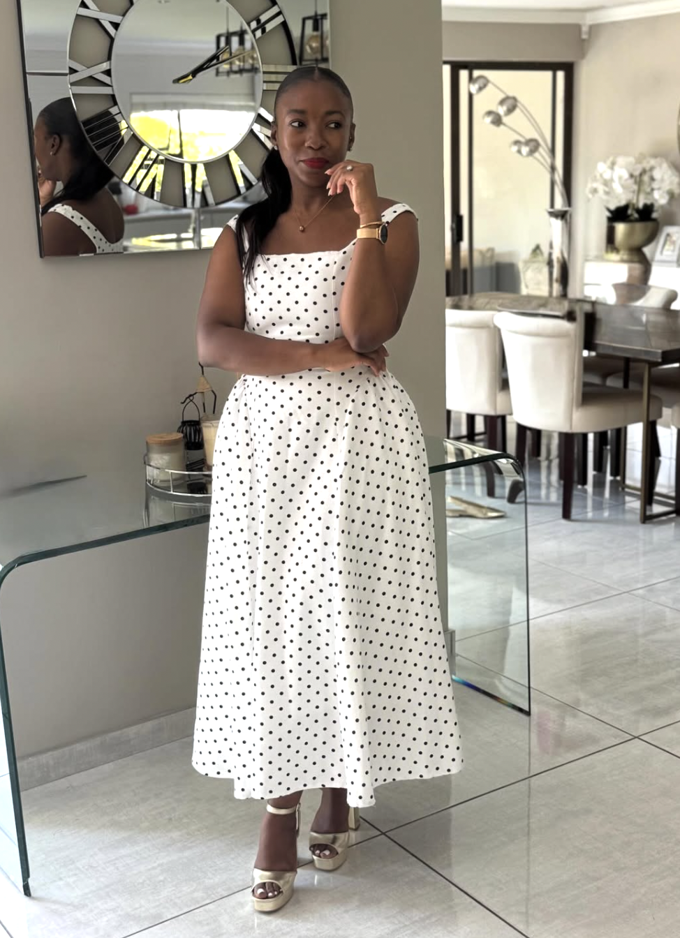 woman in a black and white polka dot dress with a bold red lip — classic summer polka dot outfit that feels editorial not retro