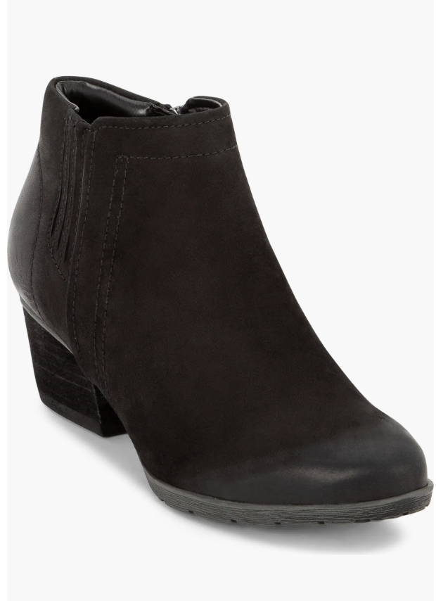 Chocolate supportive penny loafers paired with dark jeans and a striped sweater.