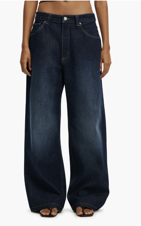 A close-up of the Cotton On Women’s Low Super Baggy Jean in a darkwash denim, featuring a relaxed wide-leg fit and low-rise waist, styled for a modern 2026 fashion editor look.