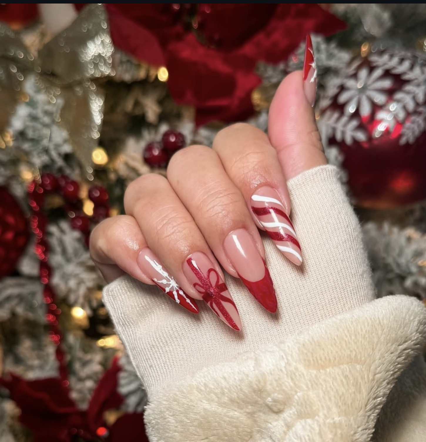 Deep red velvet Christmas nails with fine white candy cane stripes