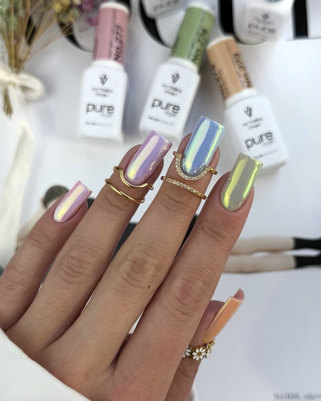 Long, square-shaped nails with an iridescent glazed donut finish reflecting brilliant shades of lavender, baby pink, and soft blue chrome light.