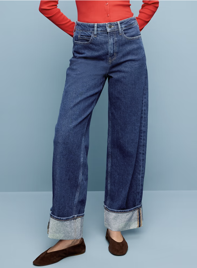 Woman styling Old Navy cuffed wide-leg jeans with a fitted fall top and flats.