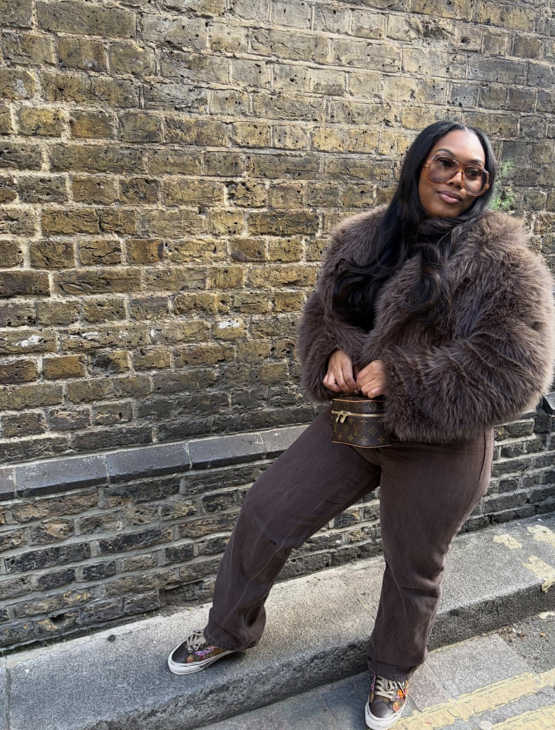 A brown textured jacket and tonal trousers.