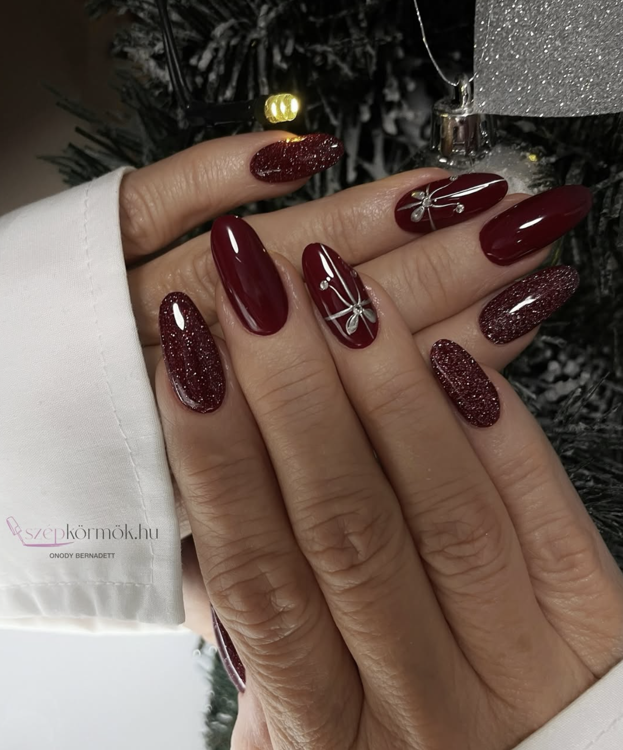 Burgundy chrome Christmas nails with a deep wine reflective finish