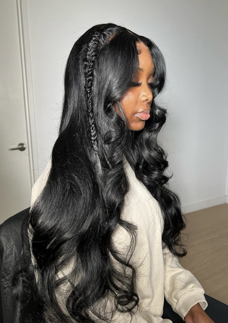 Woman wearing long curtain bangs with braids with soft face-framing movement