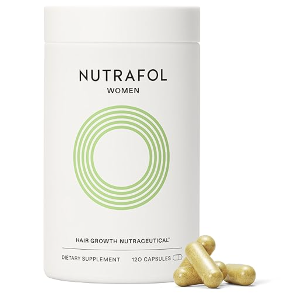 A white bottle of Nutrafol Women's Hair Growth Supplement with green concentric circle branding, shown next to two gold liquid capsules.