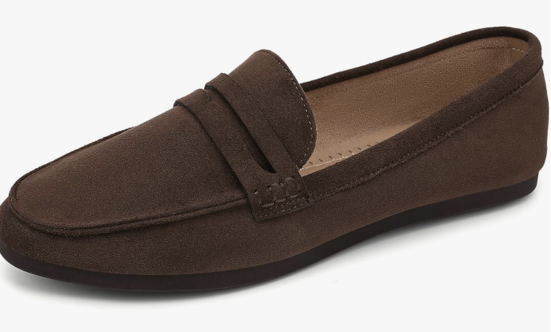 A pair of dark brown suede loafers with a classic penny strap, a structured dress shoe option for styling white straight-leg jeans.