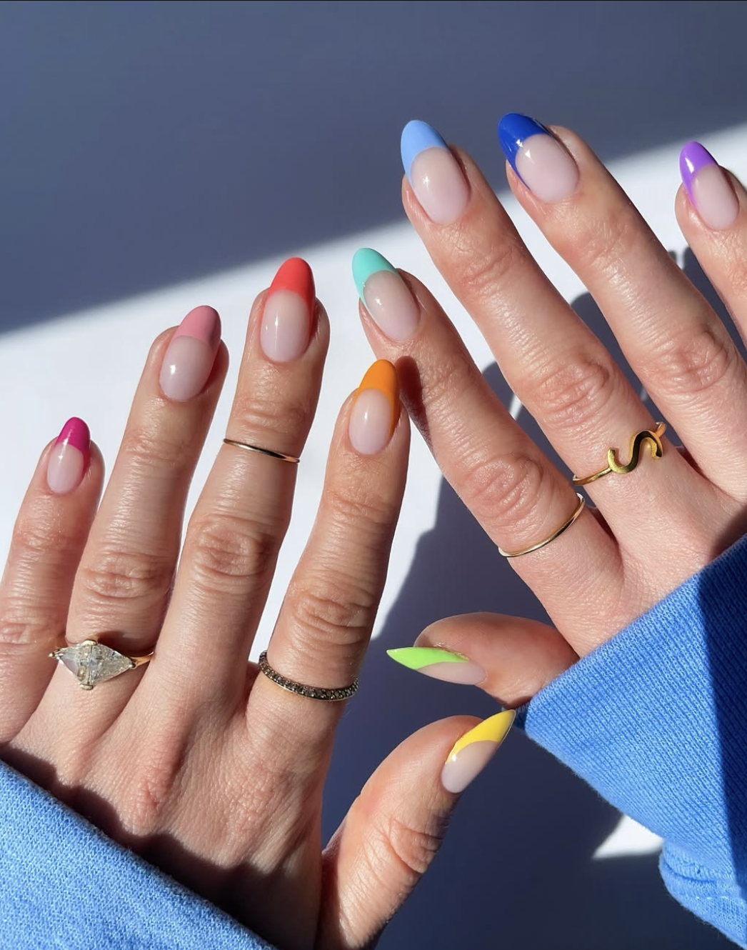 Colorful rainbow French tips with a different bright shade on every nail