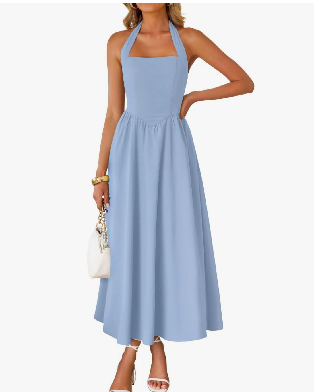 A woman wearing an elegant, light blue halter midi dress with a square neckline and a structured bodice, holding a white handbag.