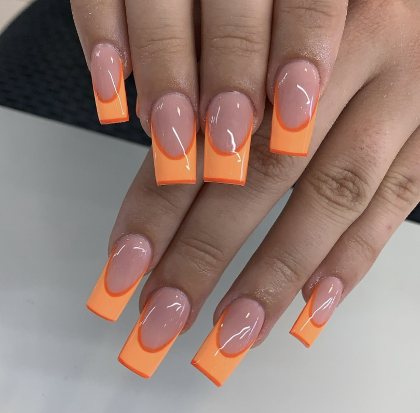 Short square nails with vivid tangerine French tips