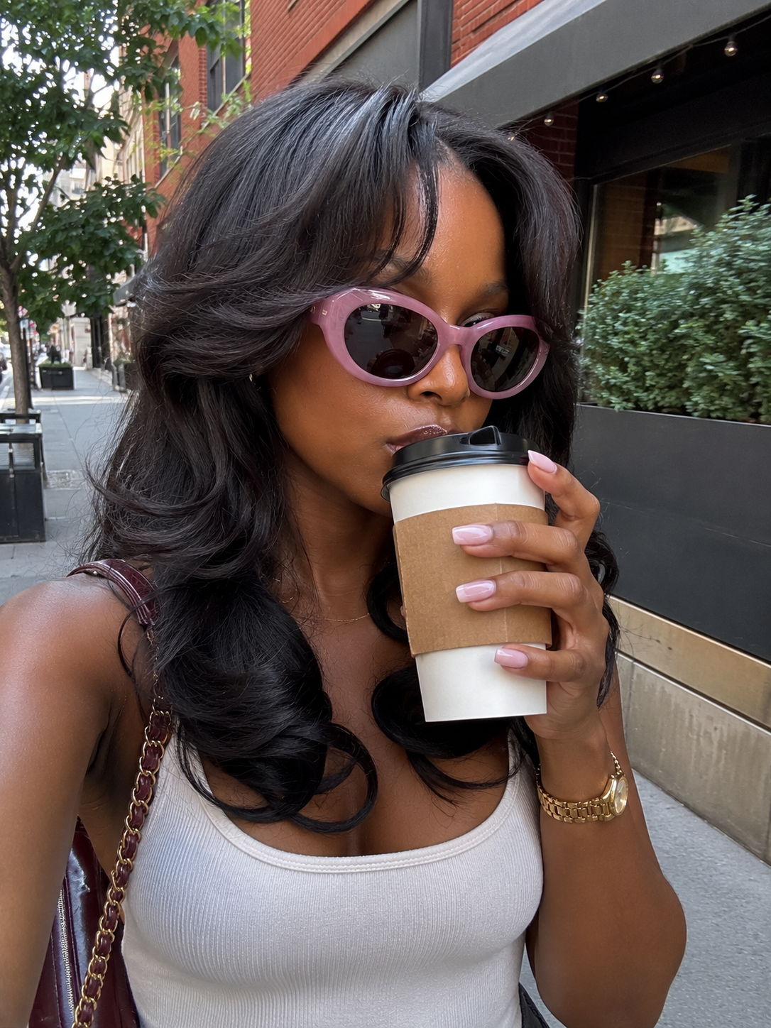 Woman wearing Sojos Lace Coral sunglasses with translucent pink frames, a key style for the 2026 candy-toned eyewear trend.