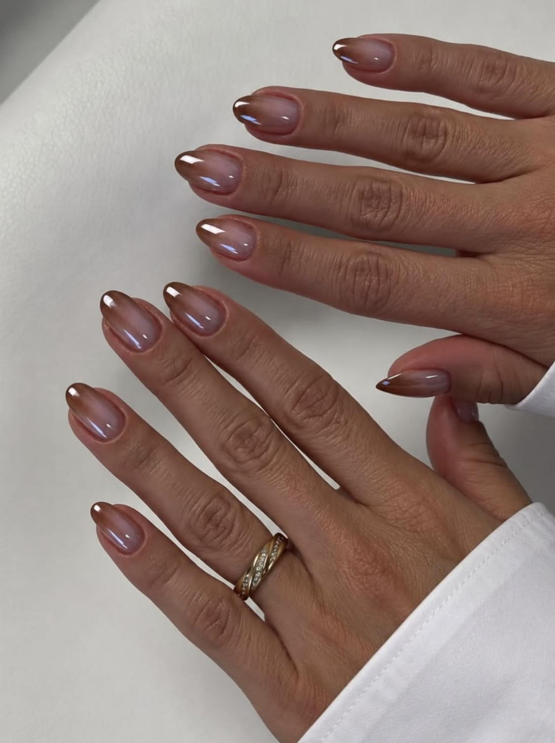 caramel glazed nails manicure photographed close up on hands.