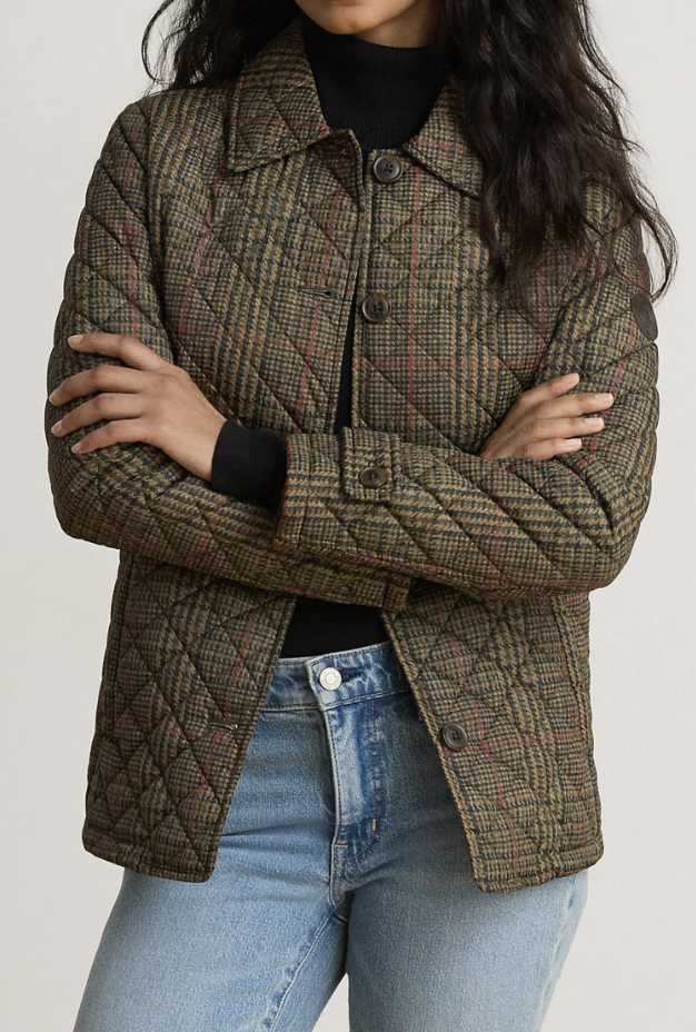 Brown and olive plaid quilted liner jacket styled with medium-wash blue jeans on a white background.