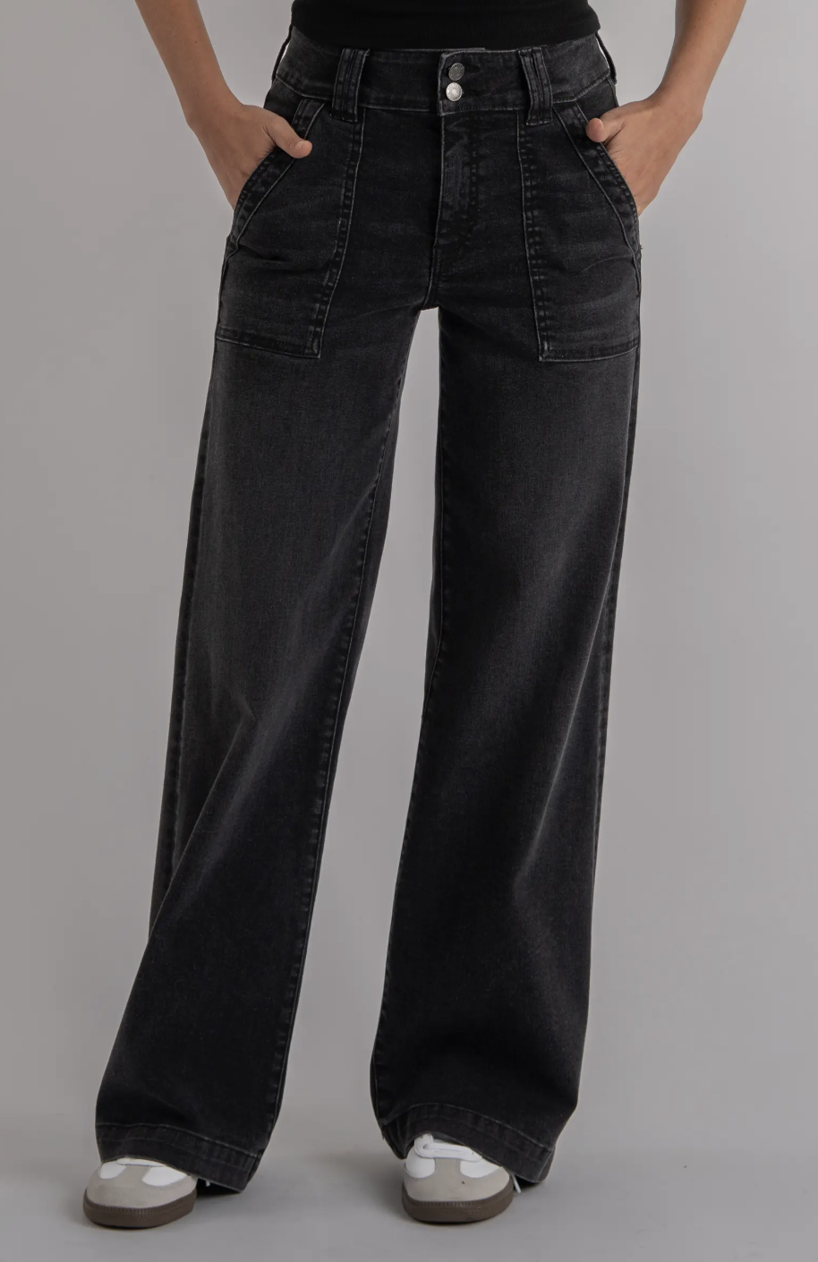 A woman wearing dark wash KUT from the Kloth Jodi High Waist Straight Leg Utility Jeans paired with white sneakers. The jeans feature a high-rise waist and vintage-inspired front utility pockets.