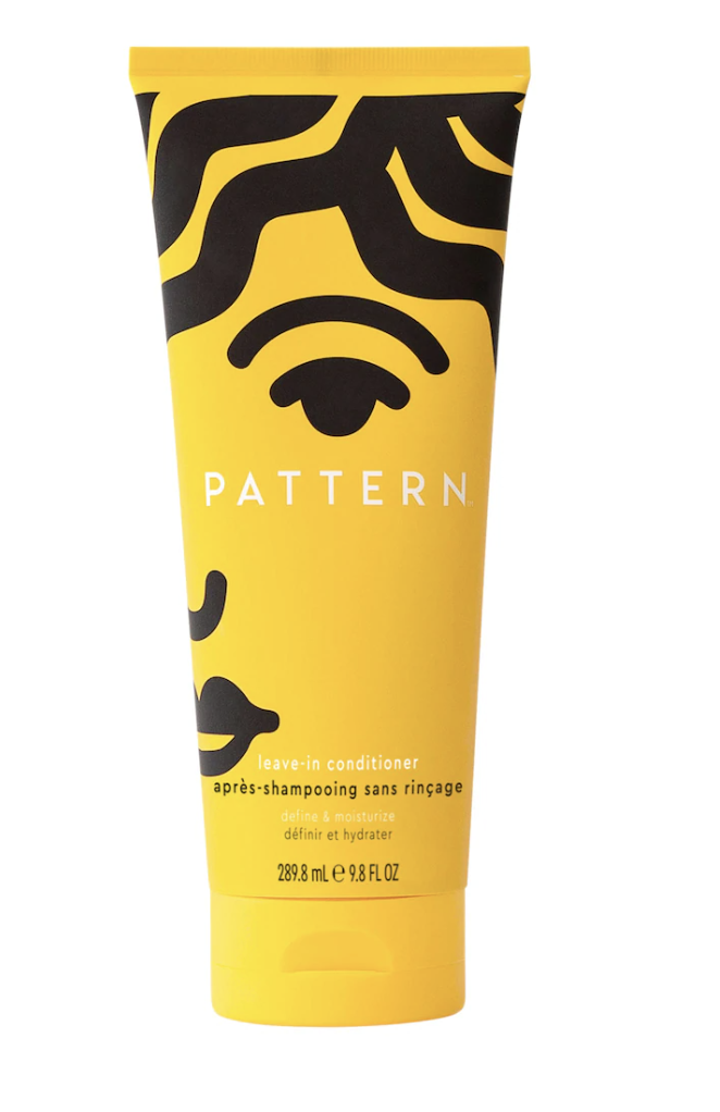 PATTERN by Tracee Ellis Ross Leave-In Conditioner in a yellow tube with black graphic art, a hydrating treatment for curls and coily 4C hair types to prevent breakage.