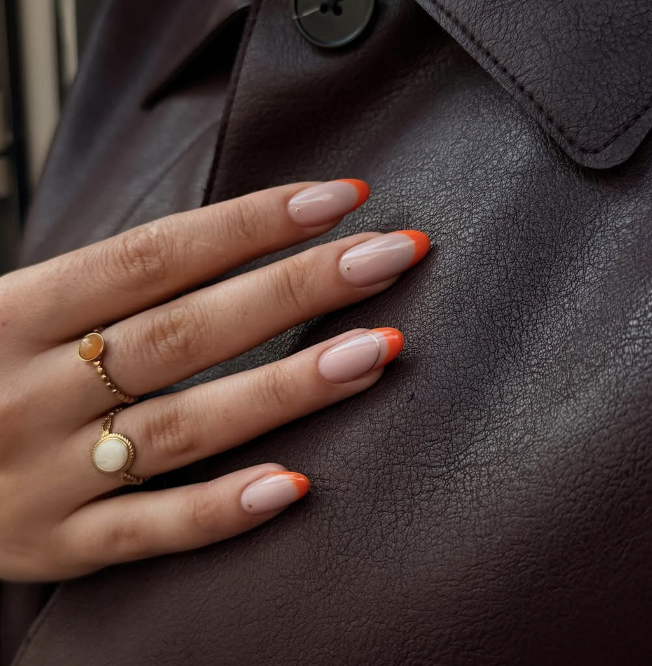 Close-up of burnt-orange double french on neatly manicured hands