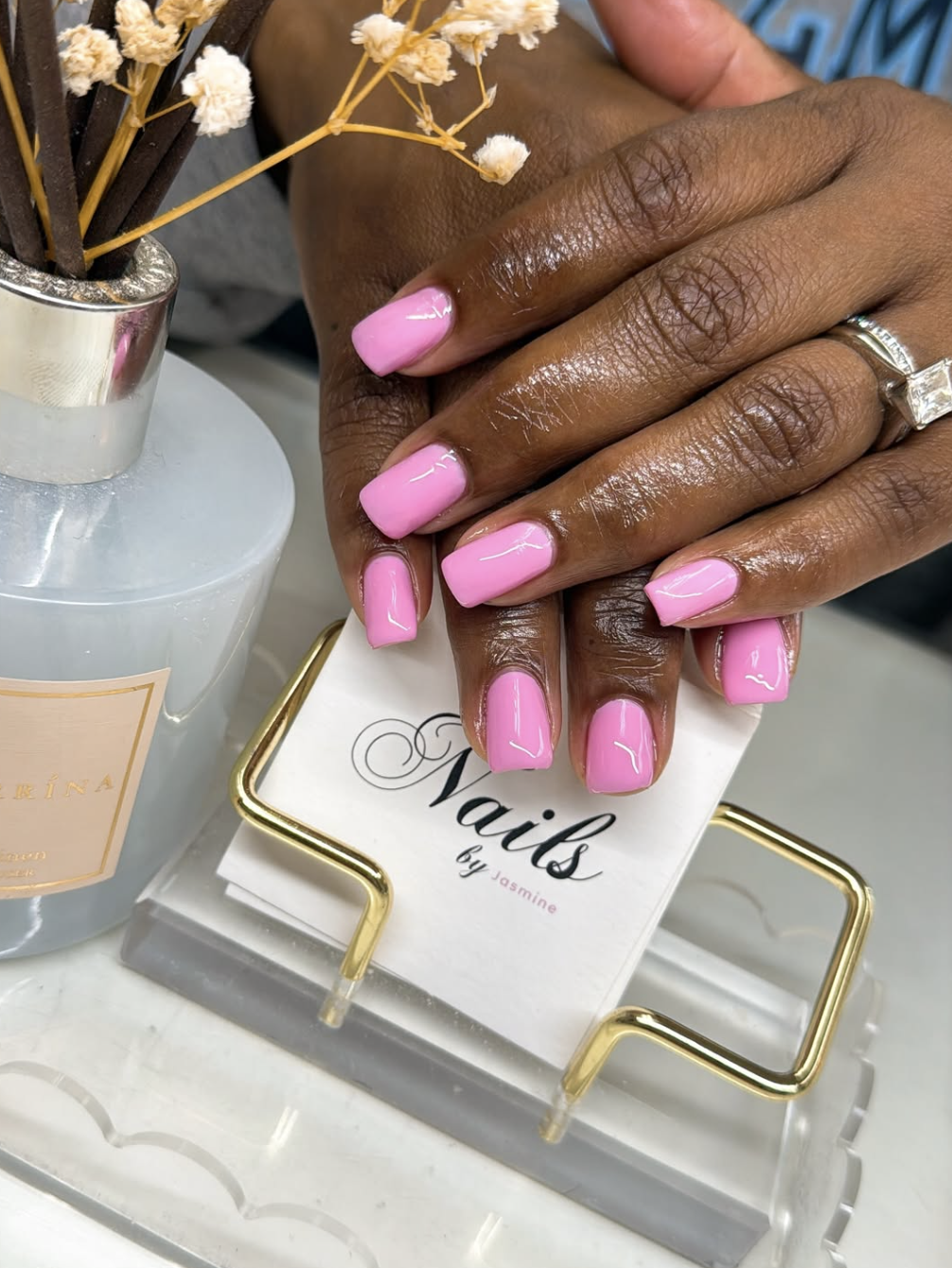 A vibrant bubblegum pink manicure on square-shaped nails, a trending summer manicure color for 2026.