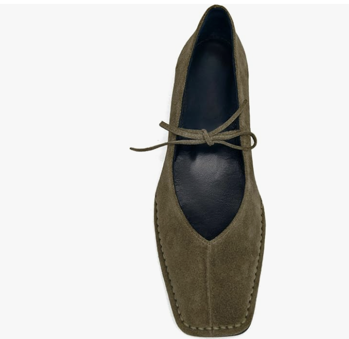 A top-down view of olive green suede square-toe ballet flats with a high-vamp silhouette and delicate lace-up bow detailing, a key footwear trend for a 2026 minimalist capsule wardrobe.