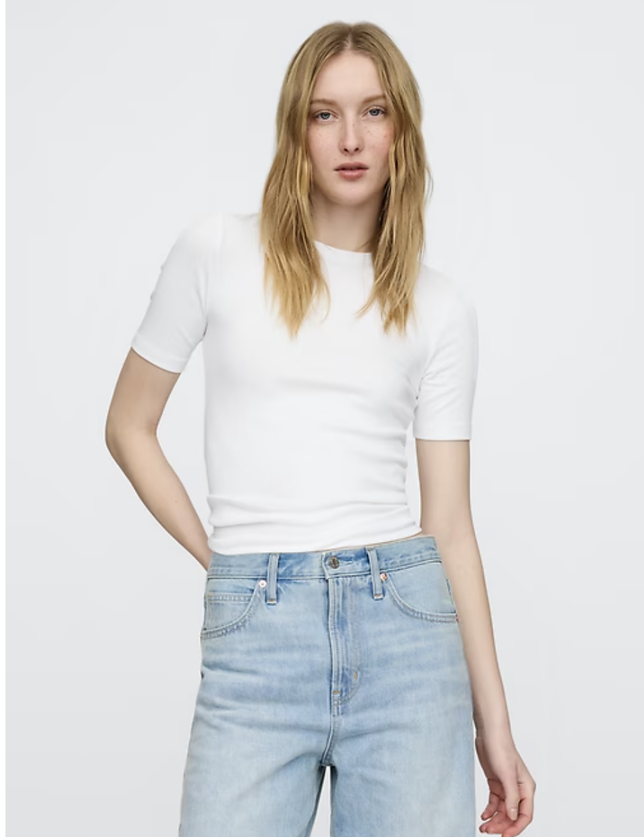 Woman wearing the GAP Modern Crewneck, a soft and opaque white t-shirt that is pre-shrunk and reliable for everyday wear.