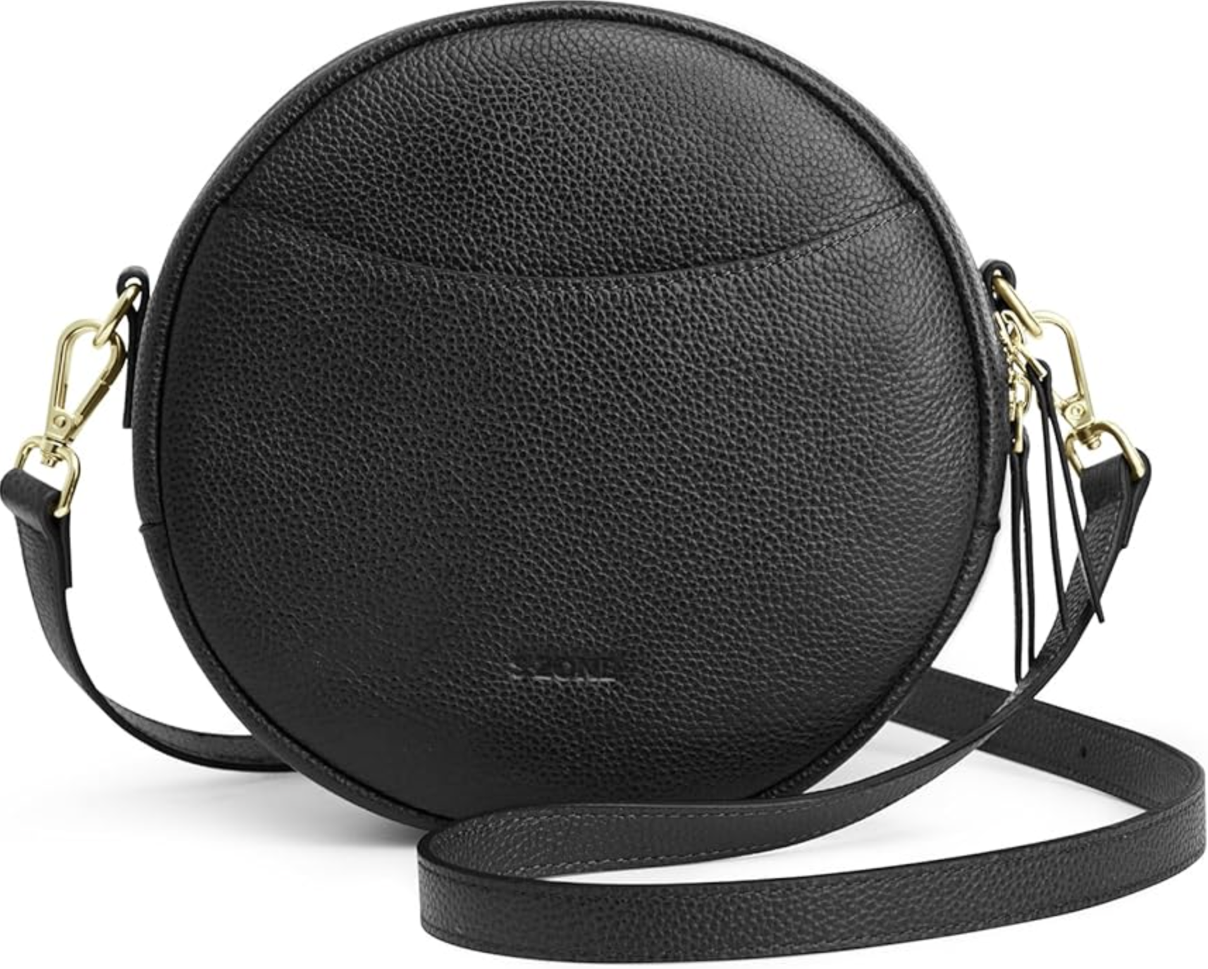A large, circular black pebbled leather handbag with a minimalist round silhouette, a black leather shoulder strap, and gold hardware.