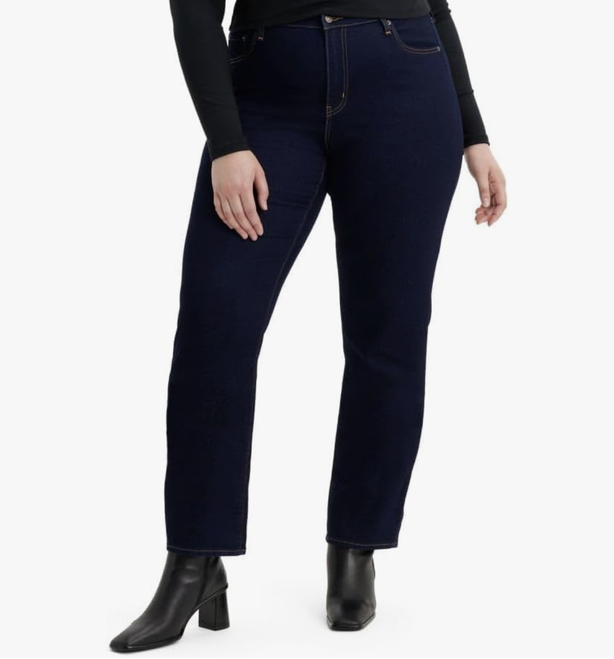 A woman wearing Levi's 724 straight leg jeans in a dark wash, showing the flattering high-rise waistband and ankle-length hem.