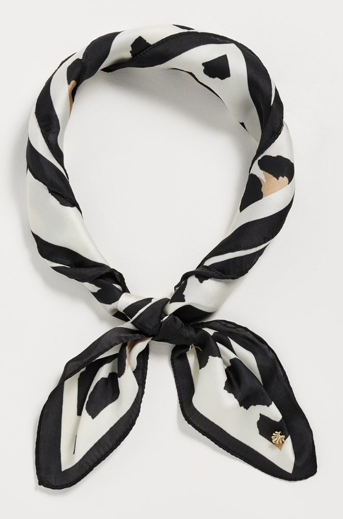 A satin square scarf featuring a classic leopard print pattern.