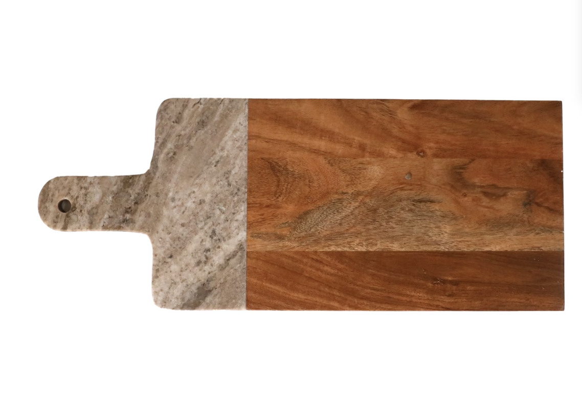 Fall grazing board with cheeses, fruit, crackers and nuts on a marble and wood serving board