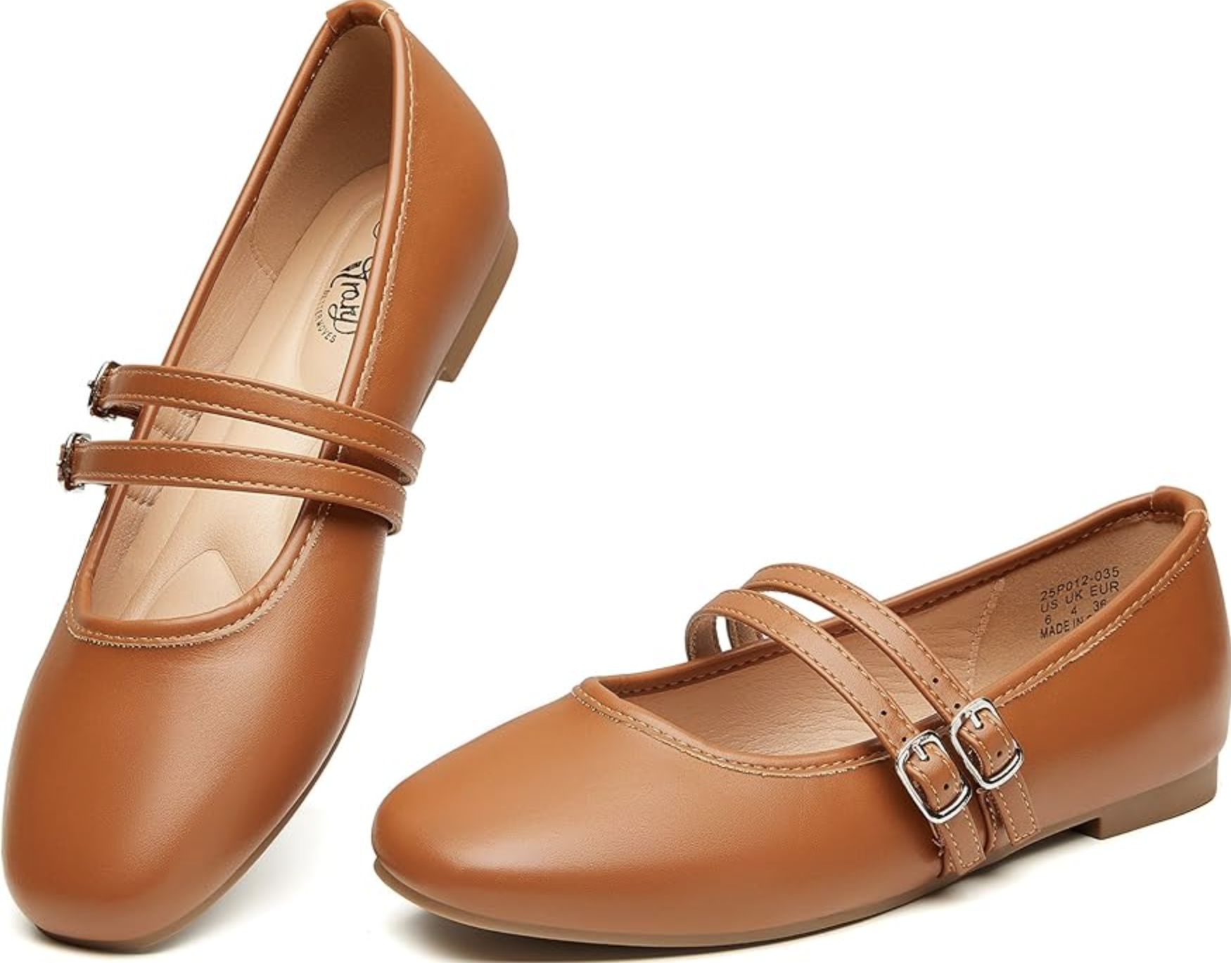 A pair of tan leather ballet flat Mary Janes for women, featuring a rounded toe, a thin adjustable strap with a small silver buckle, and a cushioned tan insole.
