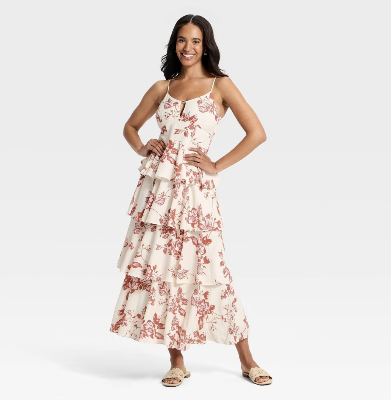 A woman wearing a white A New Day maxi dress with a v-neckline and tiered ruffle skirt, styled with strappy sandals for a summer outfit.