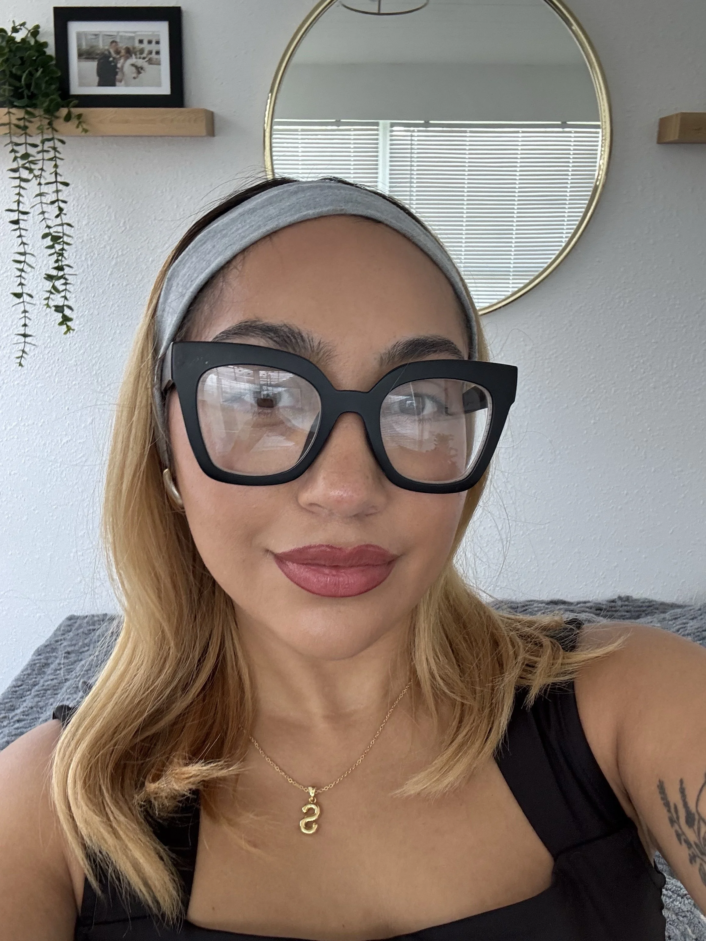 Woman with a diamond face shape wearing eyeglasses, styling inspiration for diamond face frames.