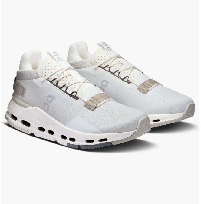 Pair of On Cloudnova 2 sneakers in white and light grey with taupe accents.