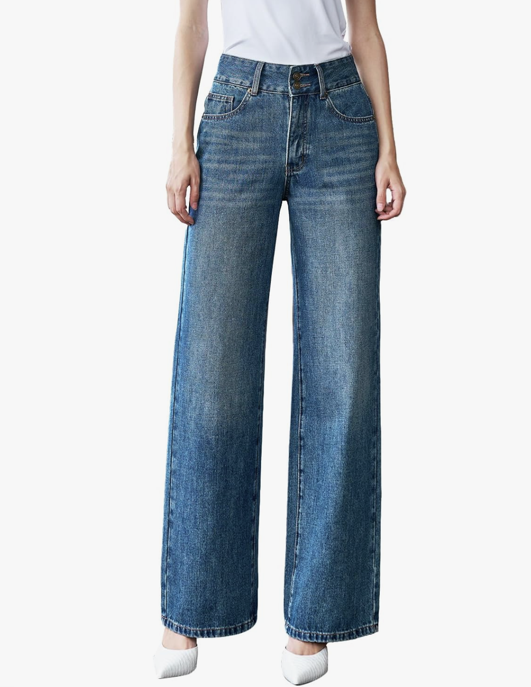 A product shot of a woman wearing a white t-shirt tucked into high-waisted baggy jeans in a medium blue wash. This illustrates a foundational piece for layering outfits as described in the "Under an Oversized Crewneck" section.