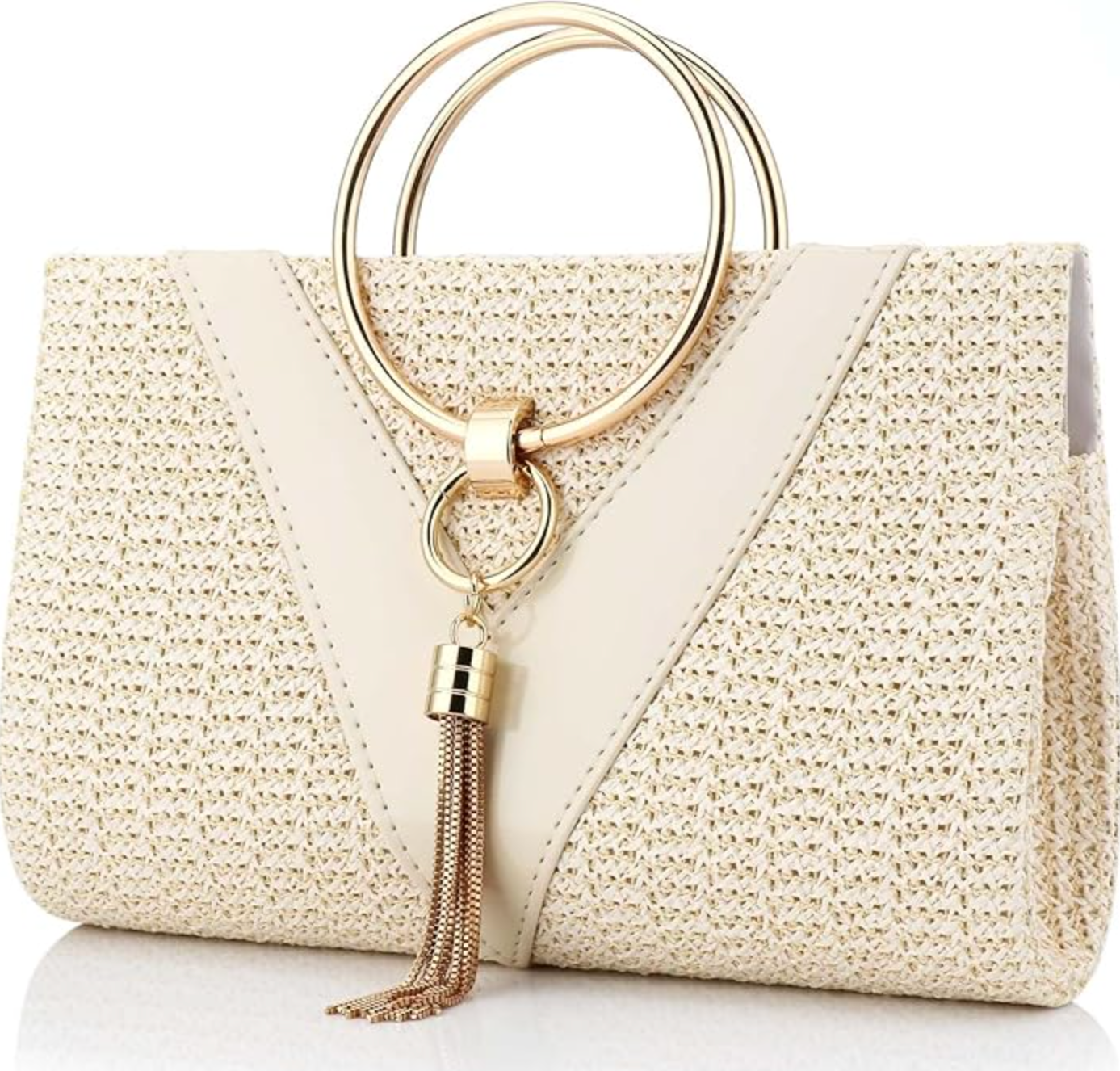 A cream-colored woven straw evening bag with a large gold ring top handle and a decorative gold tassel.