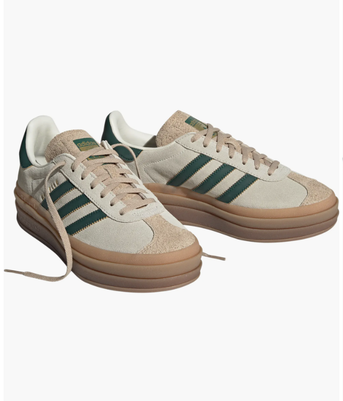 A pair of adidas Gazelle Bold platform sneakers in a neutral beige suede with dark green stripes and a stacked gum rubber sole.