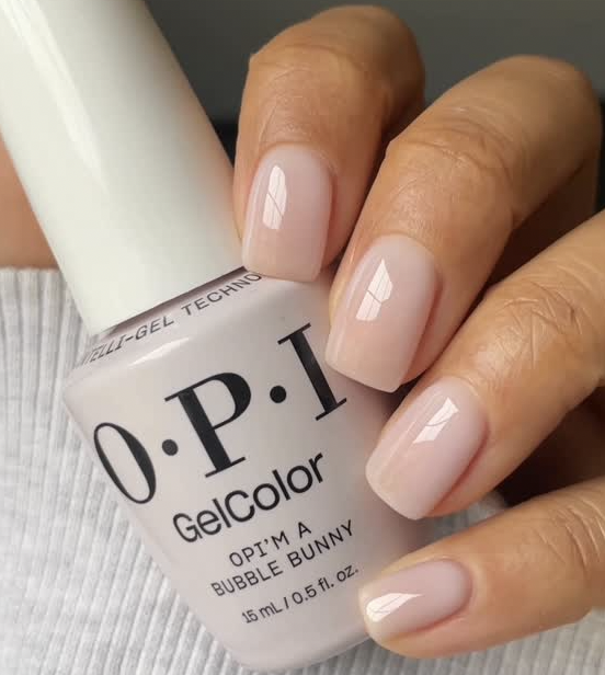 A close-up of a glossy, milky-pink manicure using OPI'm a Bubble Bunny from the New OPIcons Spring 2026 collection.