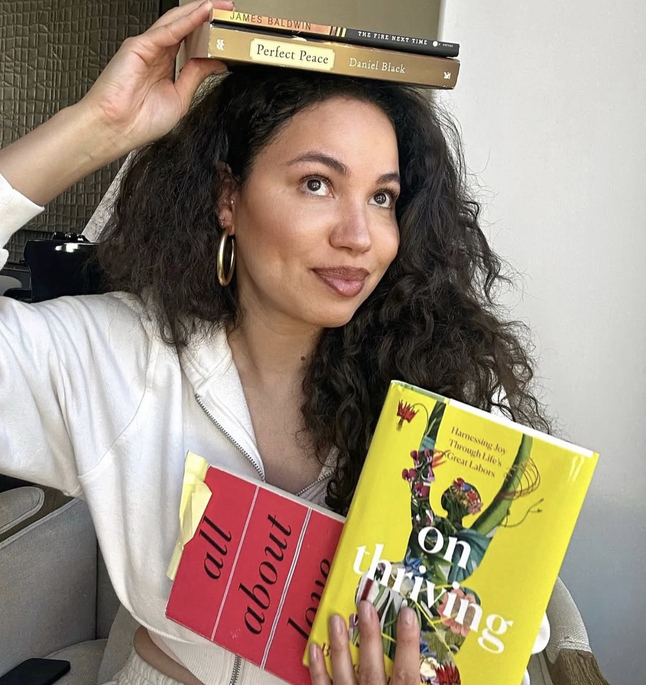 Stack of library books beside a reusable tote