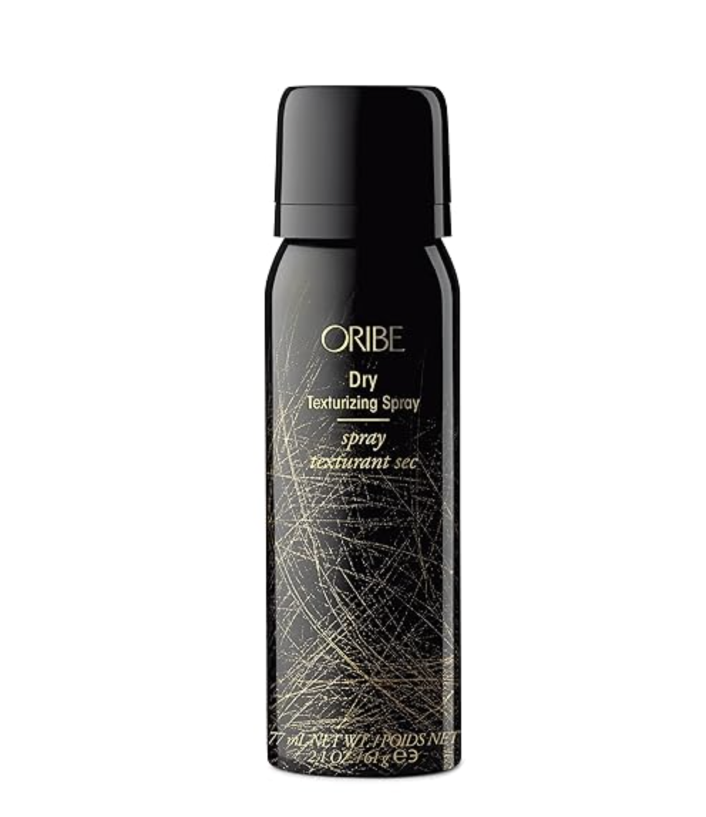 A bottle of Oribe Dry Texturizing Spray, the go-to product for achieving the 'Tornado-Struck' messy hair texture seen on the NYFW 2026 runways.